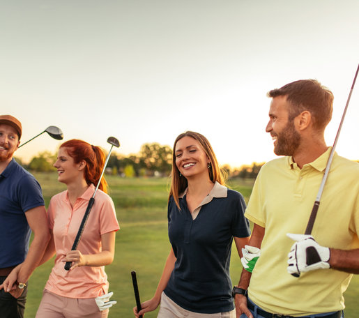 Group of people walking with golf clubs
