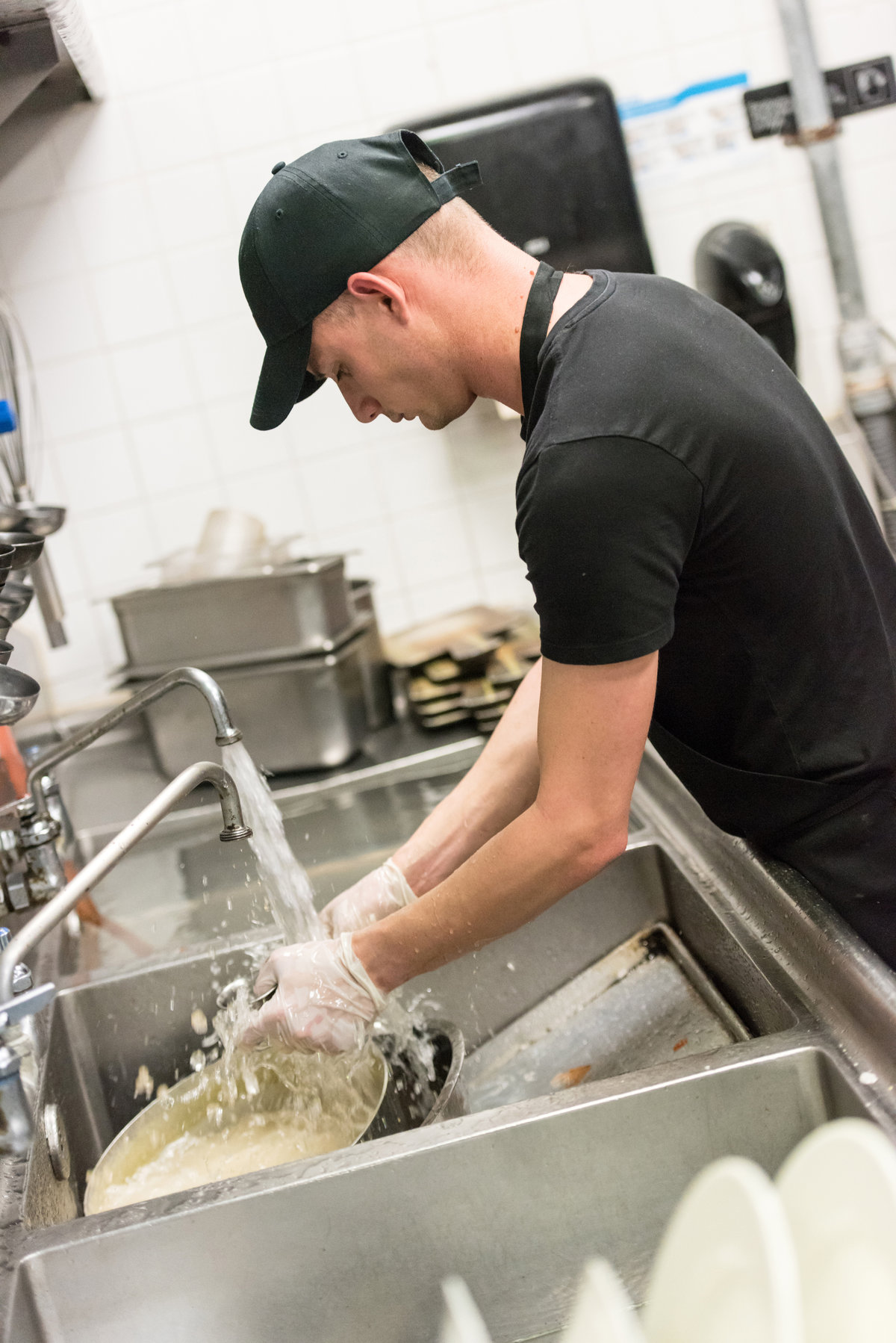 Restaurant worker washing dishes